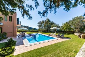 a swimming pool in the yard of a house at Villa Ithaki Kefalonia in Lourdhata