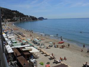 a beach with a bunch of people on the sand at Residence Fanny in Alassio