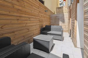 a patio with two chairs and a bench at La Suite Confidentielle - Balneo - Sauna - Hypercentre in Cannes