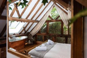 a bedroom with a bed and a sink in a room at Treehouse Cottage Spa Retreat in Hereford