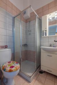 a bathroom with a shower with a toilet and a sink at Stella by Hospi in Kato Gouves
