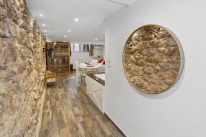 a kitchen with a stone wall and a mirror on the wall at La Suite Confidentielle - Balneo - Sauna - Hypercentre in Cannes
