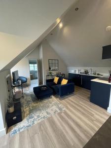 a living room with a couch and a kitchen at One Bedroom Flat near Bosham & Goodwood in Funtington