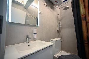 a bathroom with a sink and a toilet and a mirror at Voulis 45 Plaka Suite by Zeussuites in Athens