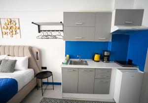 a small kitchen with a sink next to a bed at Voulis 45 Plaka Suite by Zeussuites in Athens
