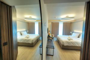 Postel nebo postele na pokoji v ubytování ASTE hotel