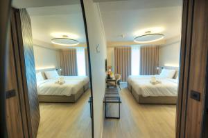 Postel nebo postele na pokoji v ubytování ASTE hotel