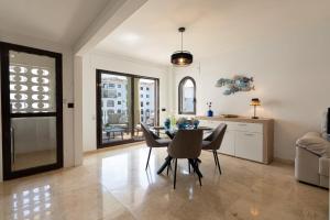 a kitchen and dining room with a table and chairs at 327 marina duquesa in Manilva