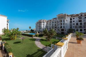a view from the balcony of a hotel with a lawn and buildings at 327 marina duquesa in Manilva