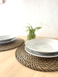 a table with plates on a wooden table at Casetta Michelina in Turin