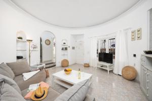a living room with a couch and a table at Villa Alisa in Tías