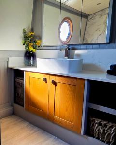 a bathroom counter with a sink and a mirror at Dragonfly at Aston Marina in Stone