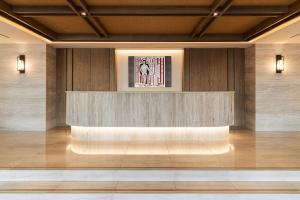 a lobby with a bench in the middle of a building at Divani Corfu Palace in Corfu