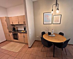 a kitchen and dining room with a table and chairs at WümmeLoft - Das City Apartment in Rotenburg an der Wümme