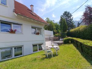 a house with a table and chairs in the yard at Ferienwohnung Erika in Badenweiler