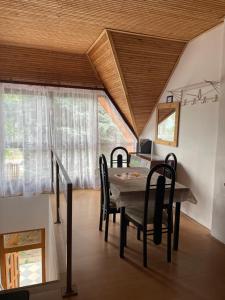 a dining room with a table and chairs at Hutter Vendégház in Szántód