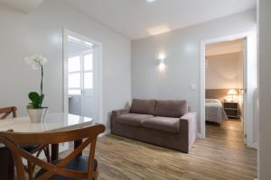 a living room with a table and a couch at Apart Hotel Garibaldi in Porto Alegre +7 photos