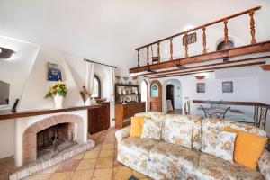 a living room with a couch and a fireplace at Charming Villa, with terrace overlooking the sea, Amalfi coast, 170 steps from the road in Conca dei Marini
