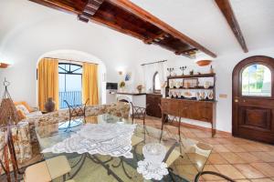 a living room with a table and chairs at Charming Villa, with terrace overlooking the sea, Amalfi coast, 170 steps from the road in Conca dei Marini
