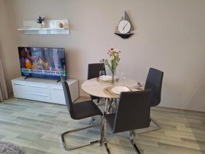 a dining room with a table with chairs and a laptop at Apartment Maraya 2, Carpe Diem complex, Balchik, free parking in Balchik