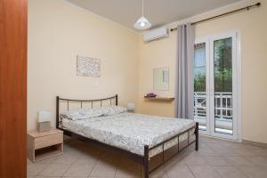 Posteľ alebo postele v izbe v ubytovaní Nostos - Psili Ammos Apartments