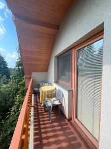 a balcony with a table and chairs on it at Hutter Vendégház in Szántód
