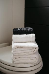 a stack of towels sitting on top of a toilet at The Loft - Stargazing Tiny Home with Firepit, Wood Fired Pizza Oven & Movie Projector in Deseronto +42 photos