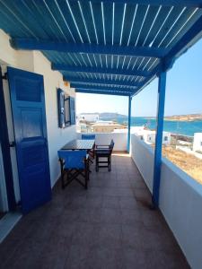 a view from the balcony of a house with a blue ceiling at Evdokia 4 in Koufonisia