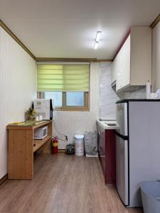 a small kitchen with a counter and a refrigerator at Suncheon Doran Doran House in Suncheon +37 photos