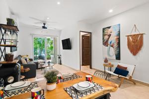 a living room with a couch and a table at Eclectic Akumal Retreat Pool Beach Wi-Fi Tulum in Tankah