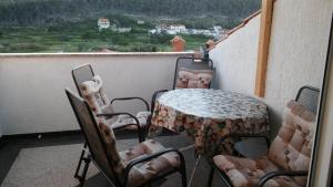 a table and chairs sitting on a balcony with a view at Apartment Lopar in Lopar