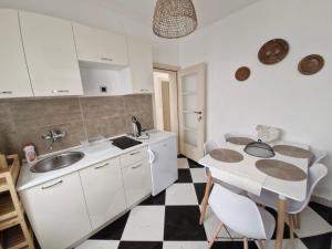 a kitchen with a sink and a table at Holiday house Ogi in Bar