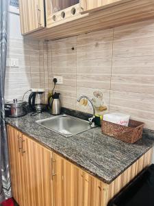 a kitchen with a sink and a counter top at Studio Villa in Kampala +18 photos