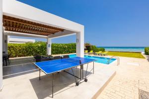 a tennis court in the backyard of a villa at Villa Metis in Lachania
