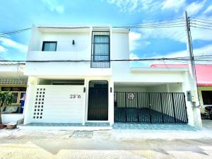a white house with a gate in front of it at Modern ZEN Vibe 3BR Pool Villa Phuket in Ban Tha Khreng