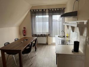 a kitchen with a table and chairs in a room at Pension Highway - Bünde Carl Diem Straße 46 in Bünde +10 photos