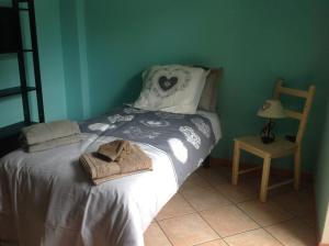 a bed in a room with a chair and a table at Matt Home in Verrès