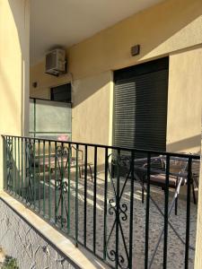 a balcony with a black fence and a table at SMYRNA HOMES CHiOS ERATO in Chios +9 photos
