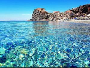 a body of water with a beach and a city at Zia Caterina in Scilla