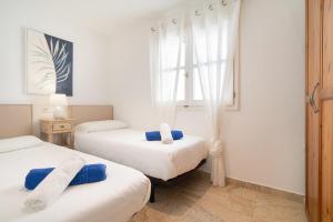 a bedroom with two beds and a window at Golf y Mar A Suites in Costa Teguise +15 photos