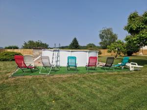 a group of chairs sitting in a yard at Chambre d'hôtes in Saint-Martial-de-Valette