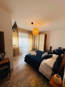 a bedroom with a large bed with a blue blanket at Stella dei Venti B&B in San Salvo +27 photos