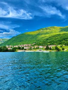 a view of a body of water with a mountain at Apartman Smaragd Lux in Plužine