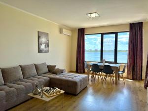 a living room with a couch and a table at Cosher Gardenia Palace Apt 6 Free Parking in Pomorie