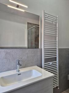 a bathroom with a sink and a mirror at Montecristo Sei in Follonica