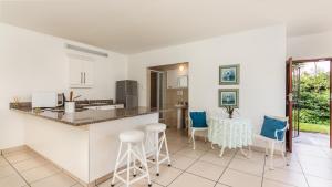 a kitchen and living room with a table and chairs at 26 Marion Road in Ballito