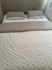 a bed with two pillows on top of it at Apartment Victoria in Foča