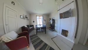 a living room with a fireplace and a couch at Medstugans Pilgrimsboende in Medstugan