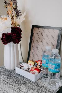a table with a vase and two bottles of water at NEW Cozy Studio Condo Prime Cebu IT Park Hotspot in Cebu City