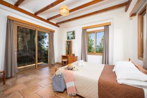 a bedroom with a large bed and large windows at Villa Angela Paradise in Argaka +24 photos